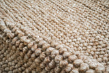 Close-up of bubble weave texture on beige wool rug