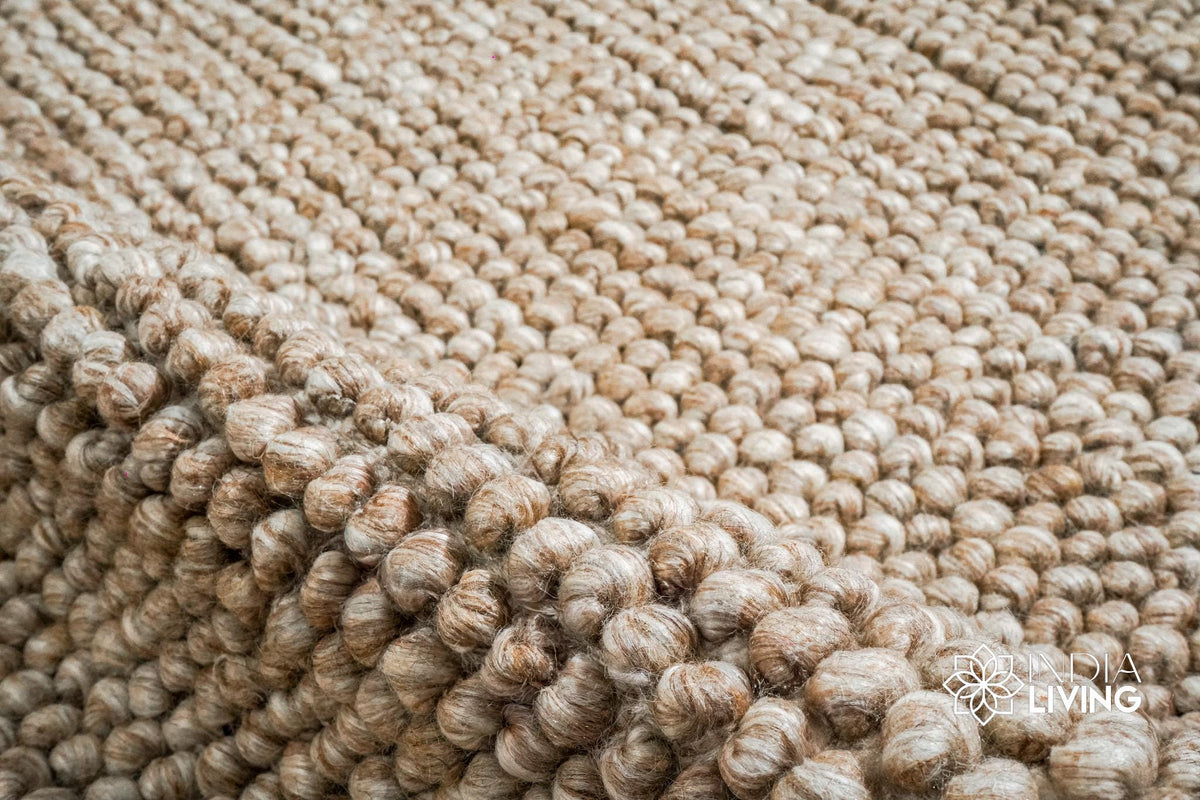 Close-up of bubble weave texture on beige wool rug