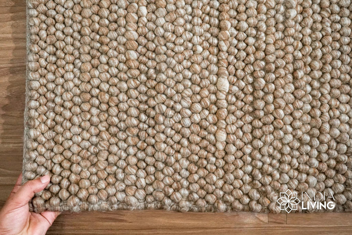 Natural beige chunky wool rug styled in a living room