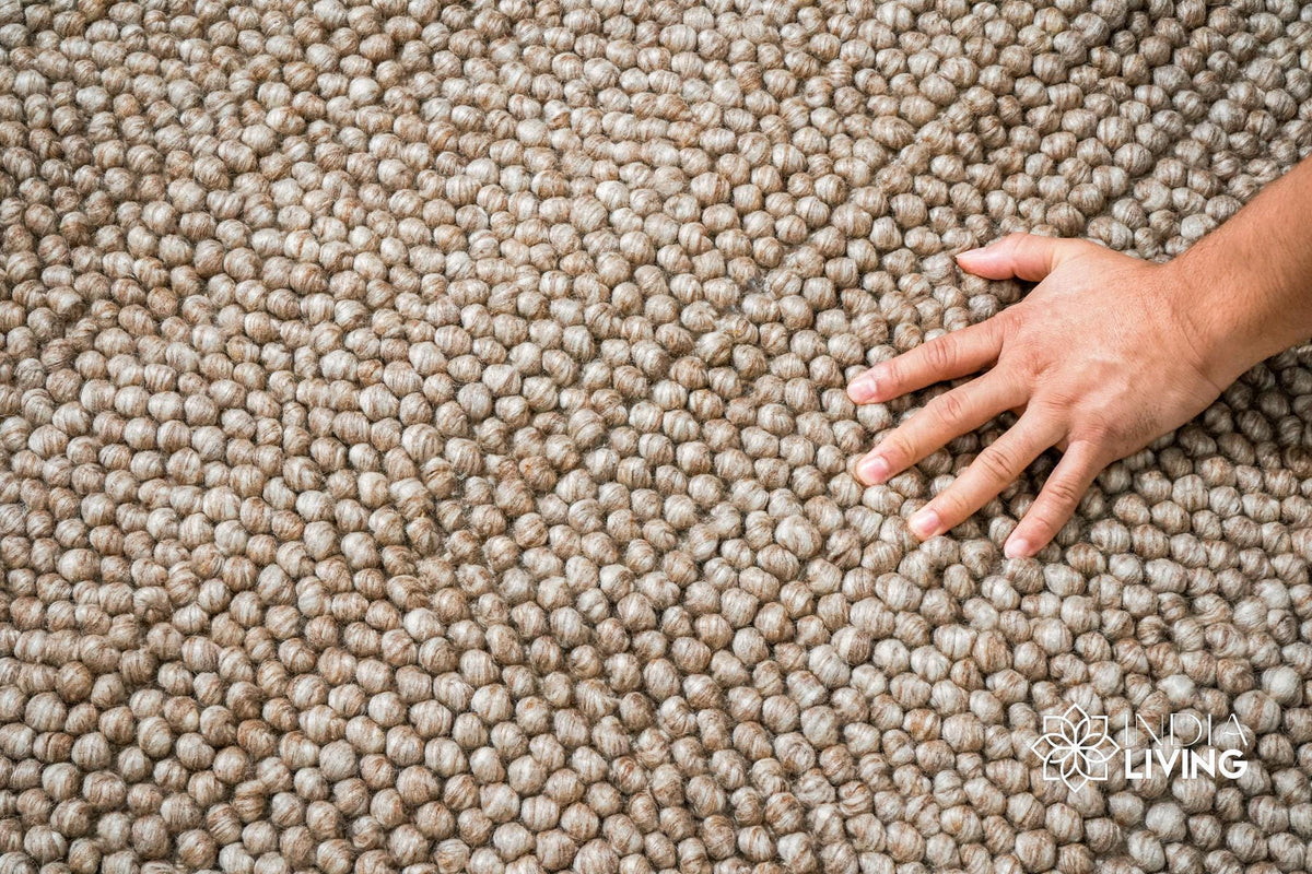 Beige chunky wool rug folded to show reversible construction