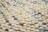 Close-up of chunky wool loop texture in pastel shades