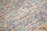 Close-up of the looped wool pile texture on the multicolour rug