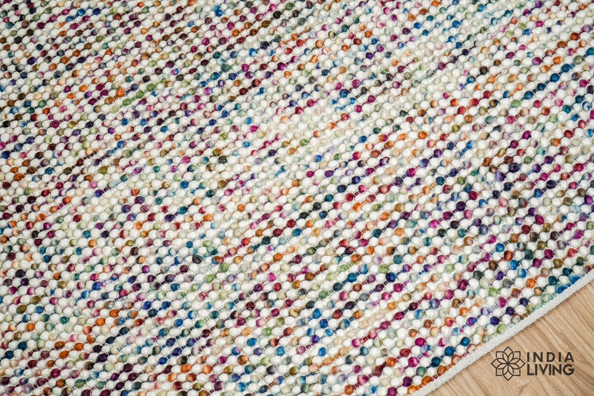 Close-up of the looped wool pile texture on the multicolour rug