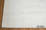 Ivory wool rug styled in a living room