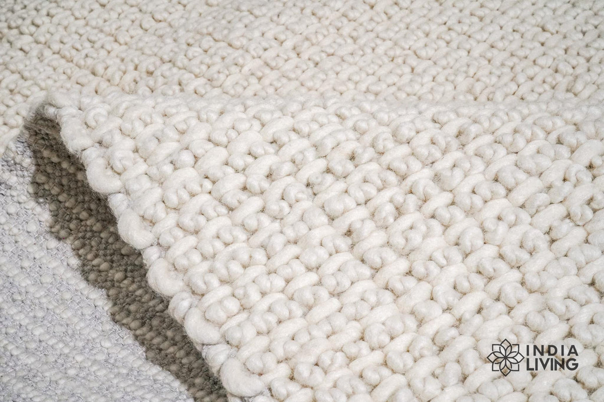 Ivory wool rug styled in a living room setting