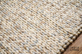 Taupe grey chunky wool rug styled in a living room