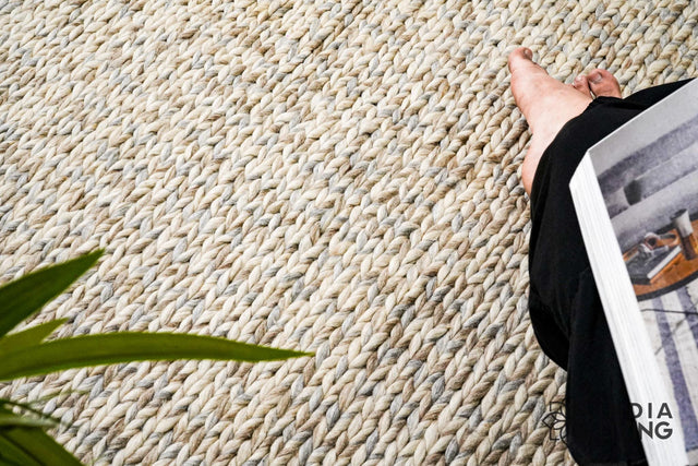 Taupe grey chunky wool rug laid flat, full cable knit texture view