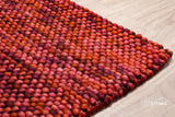 Terracotta red wool rug full view from above