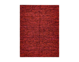 Terracotta red chunky wool rug in a hallway setting