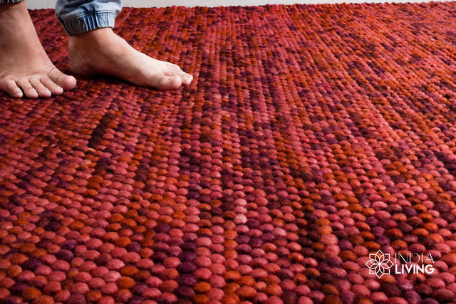 Terracotta red chunky wool rug flat lay showing thick pile texture