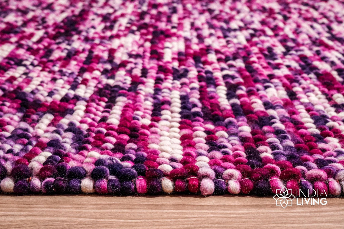 Purple wool rug styled in a living room setting