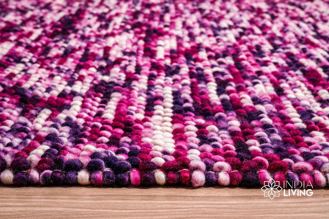 Purple wool rug styled in a living room setting