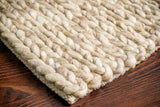 Beige chunky braided wool rug flat view