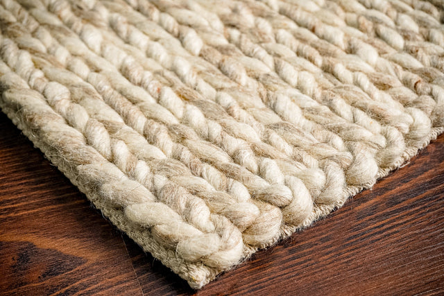 Beige chunky braided wool rug flat view