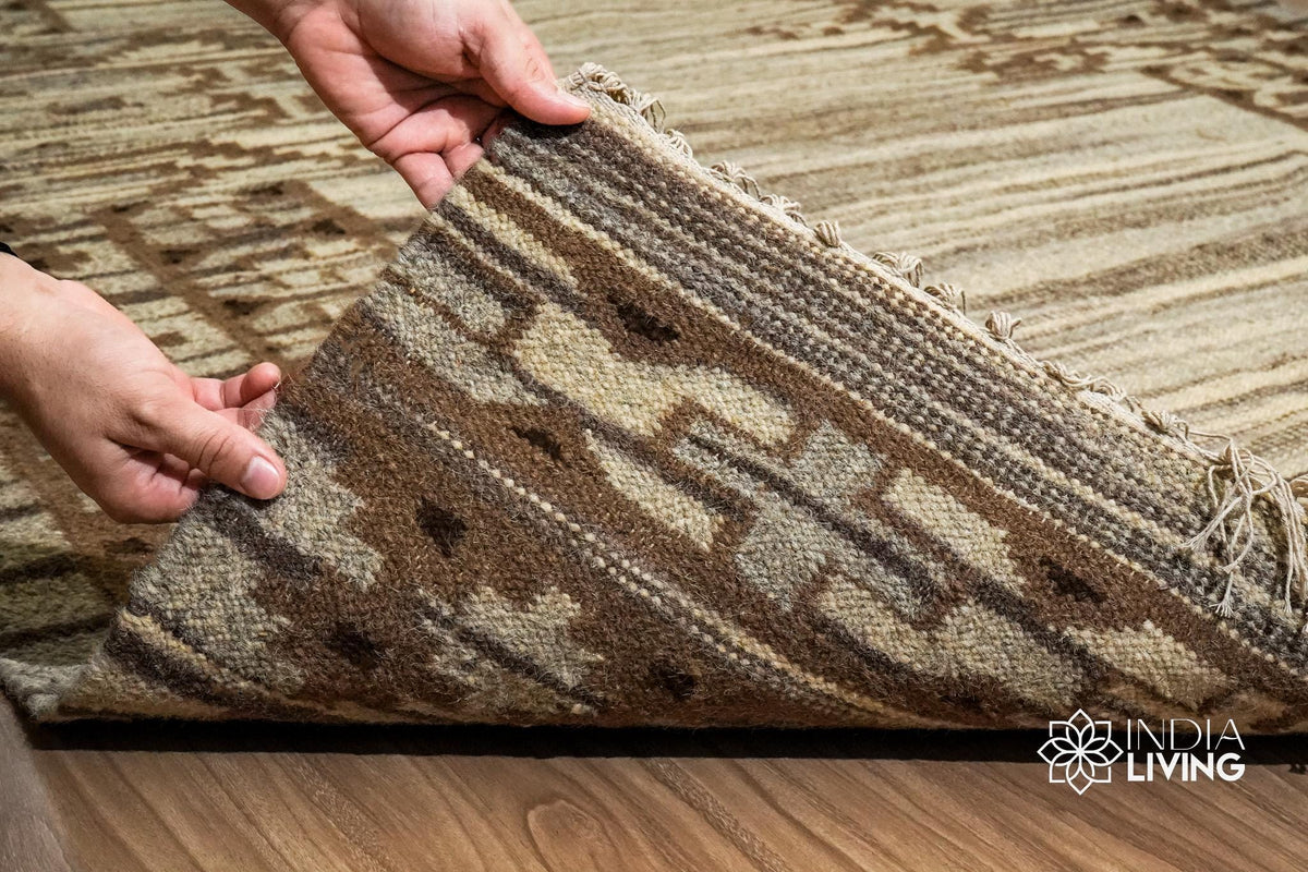 Corner view of beige wool kilim rug showing weave pattern