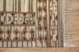 Beige kilim rug edge close-up highlighting braided fringe