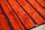 Red kilim rug styled in a bedroom setting
