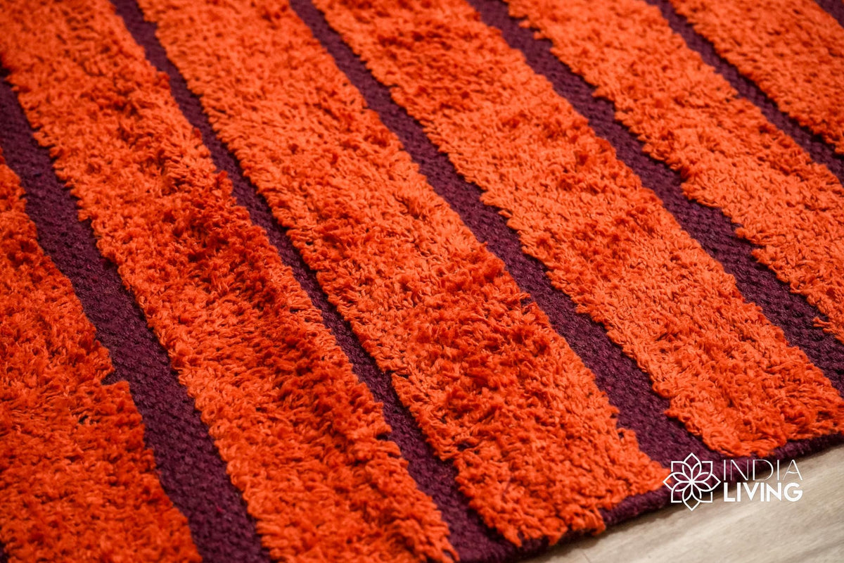 Red kilim rug styled in a bedroom setting