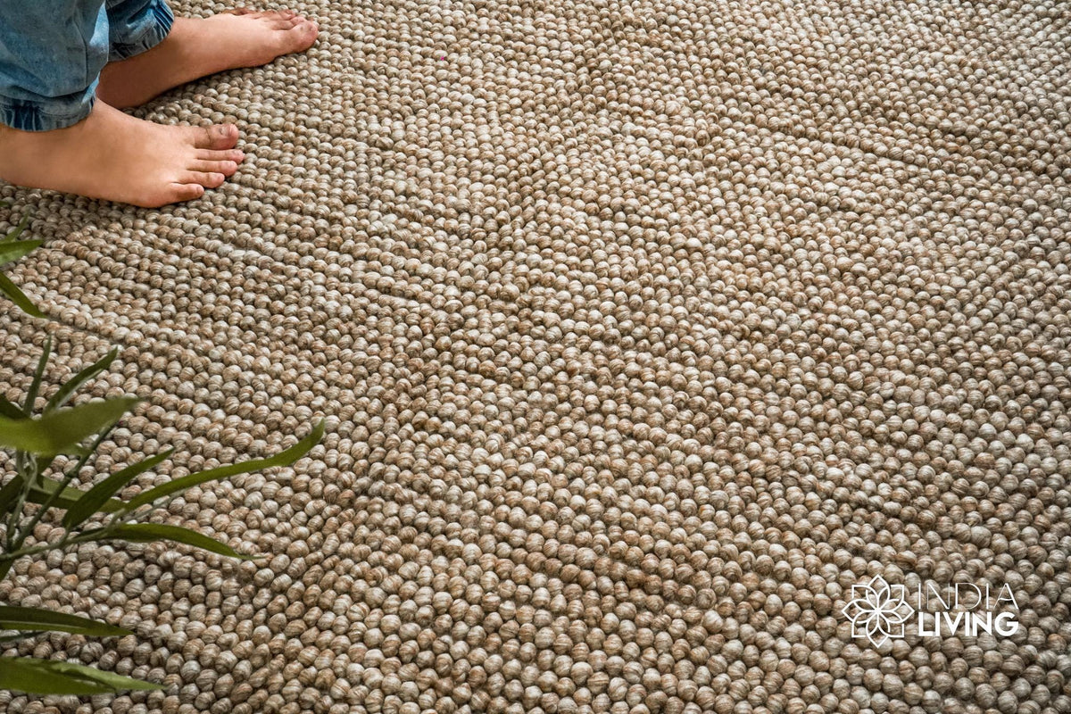 Beige wool rug edge close-up highlighting bubble weave pattern