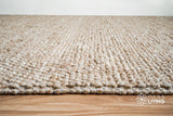 Corner view of beige chunky wool rug showing thickness
