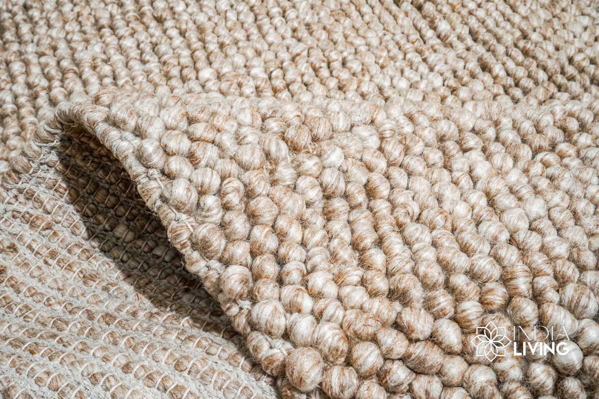 Detail shot of wool fiber texture on beige rug