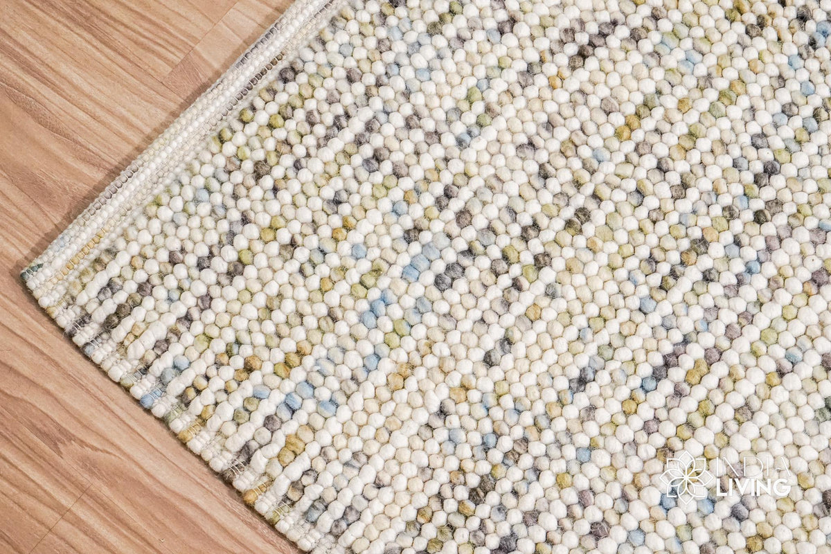 Pastel wool rug shown at an angle in room decor