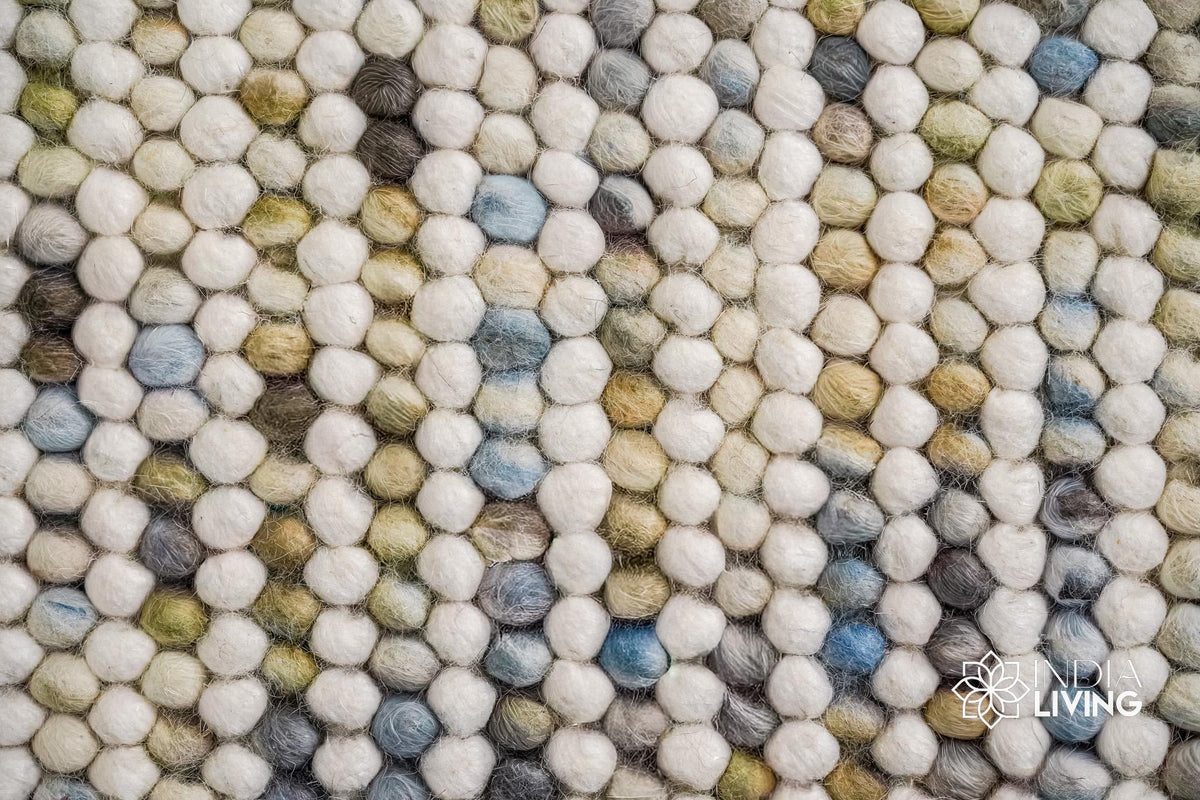 Full view of pastel chunky wool rug on wood floor