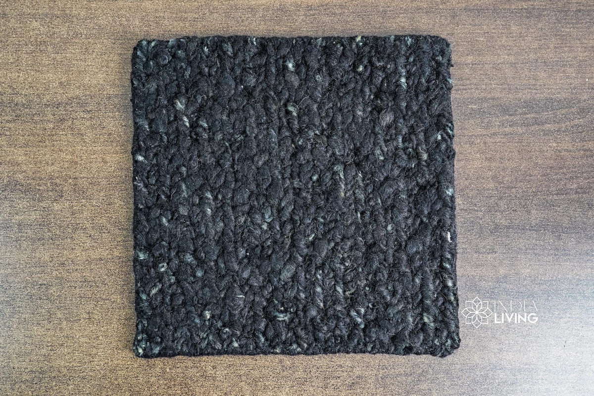 Black wool rug corner detail showing pile