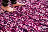 Purple chunky wool rug flat lay showing thick pile texture