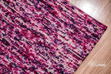 Close-up of purple wool rug chunky loop pile