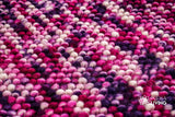 Purple wool rug placed under furniture in a living space