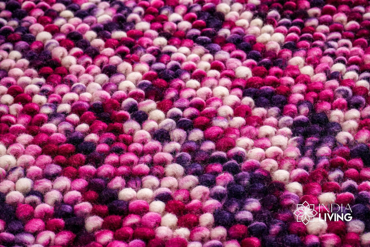 Purple wool rug placed under furniture in a living space