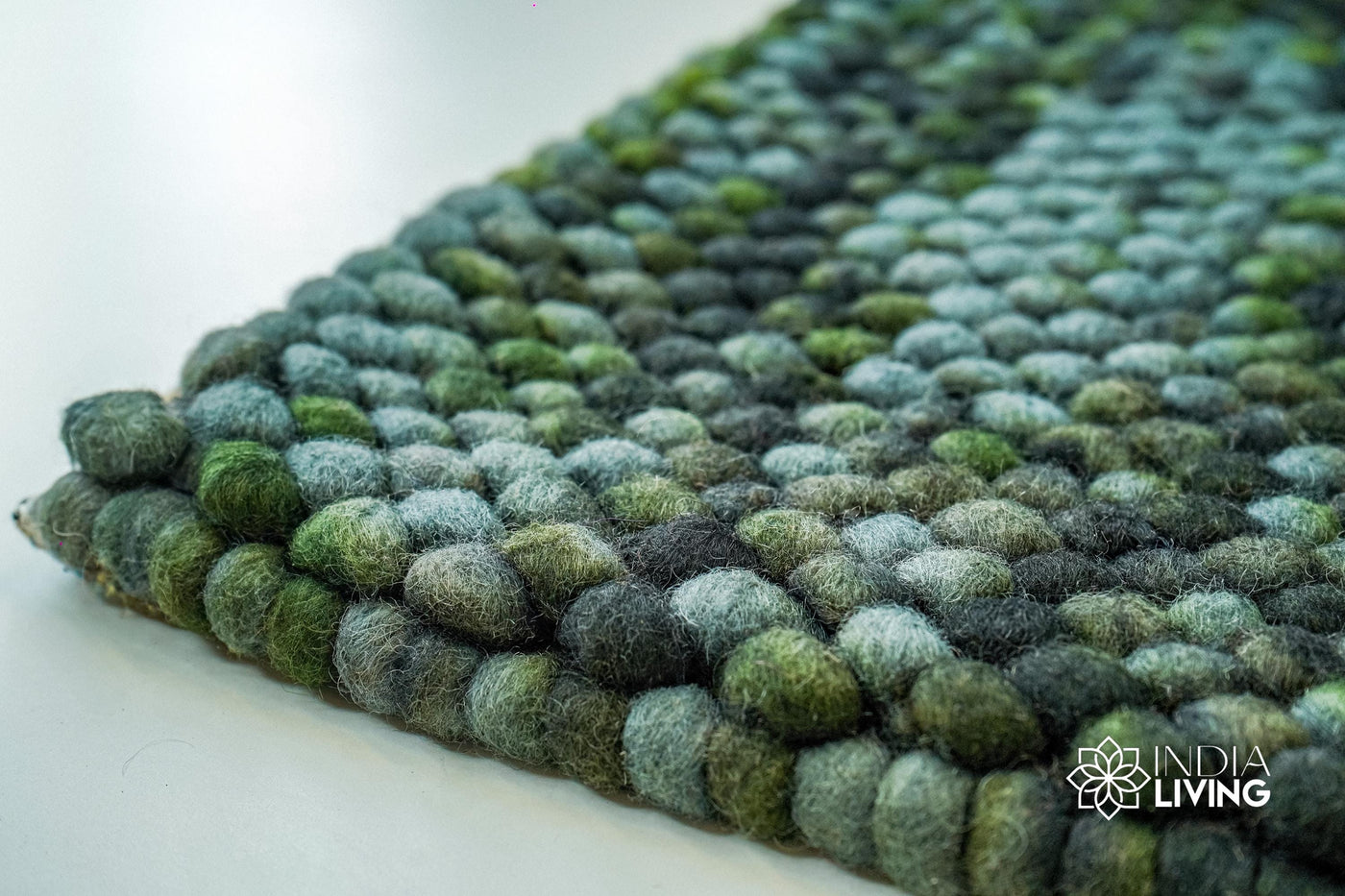 Moss green felted chunky wool rug, flat lay view