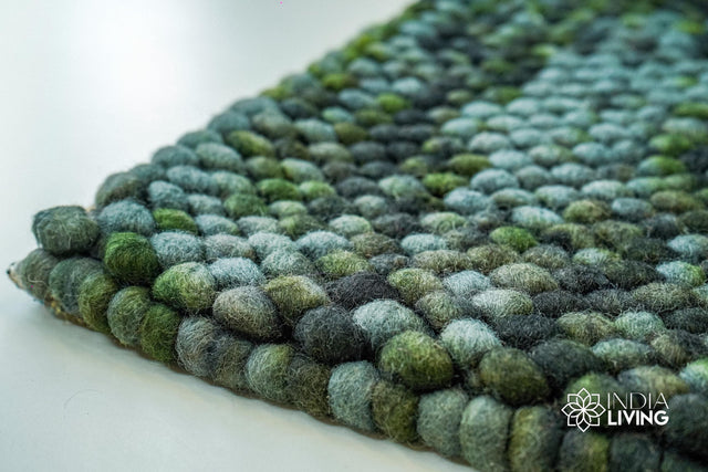 Moss green felted chunky wool rug, flat lay view