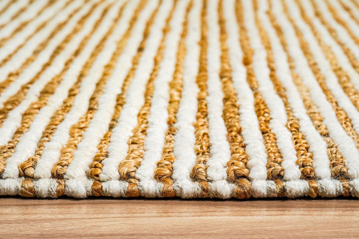 Natural ivory wool jute rug styled beside furniture