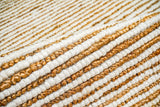 Natural ivory wool jute rug folded to show pebble weave construction