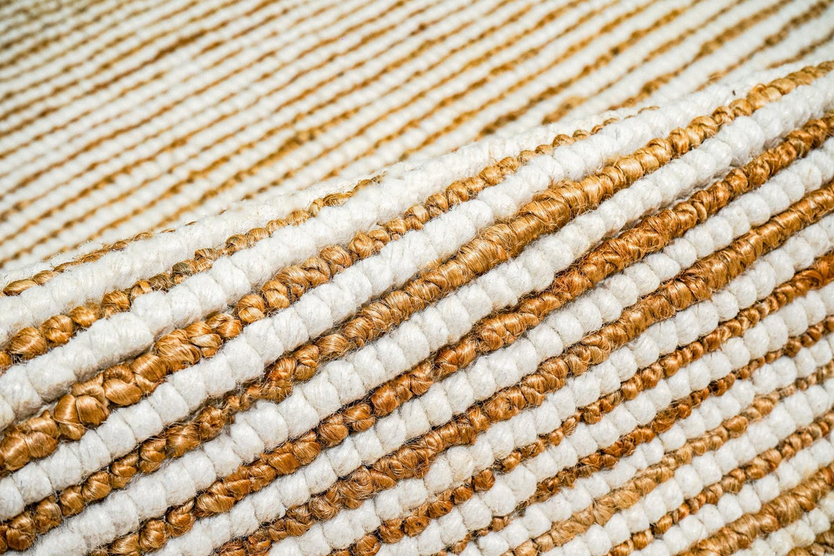 Natural ivory wool jute rug folded to show pebble weave construction