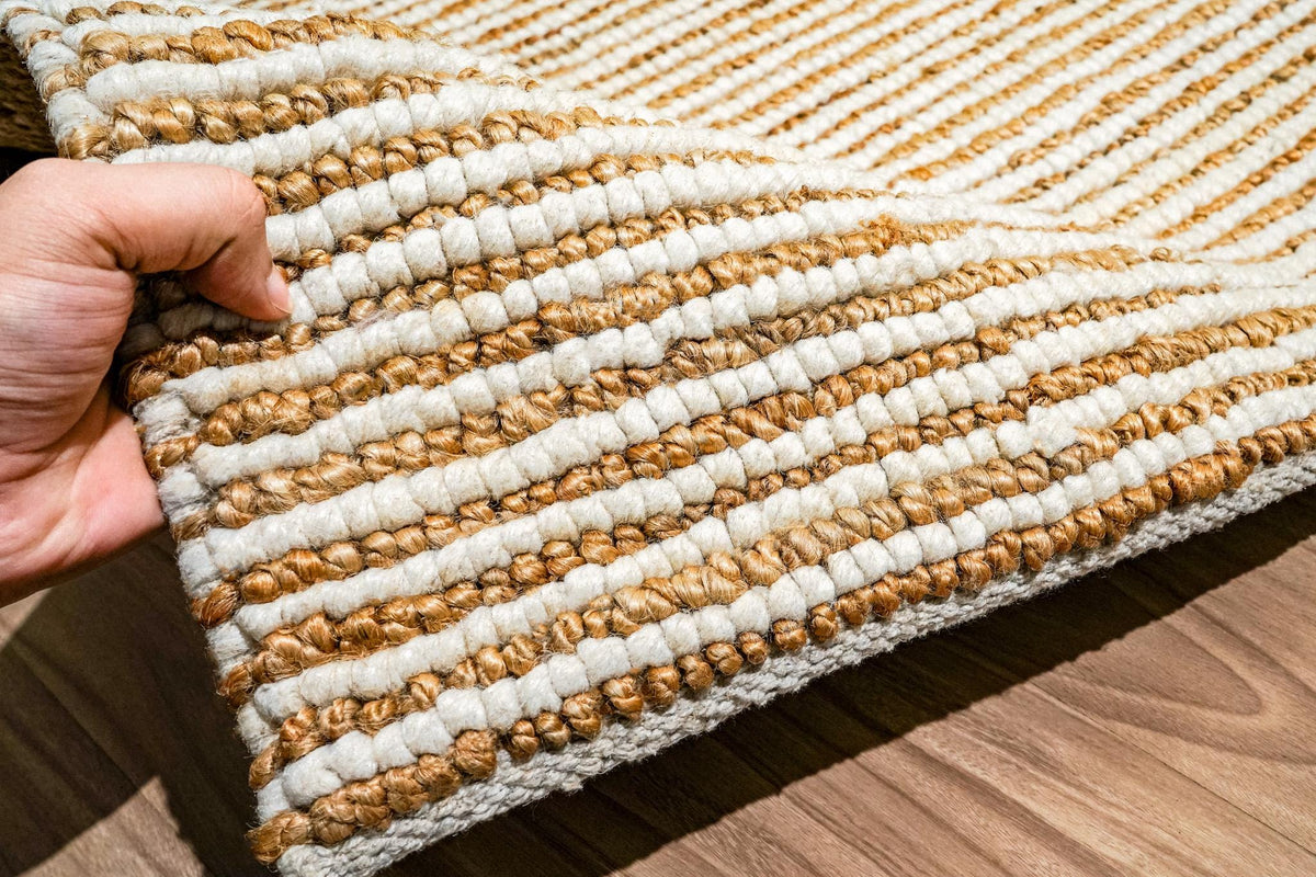 Natural ivory wool jute rug texture close-up in natural light