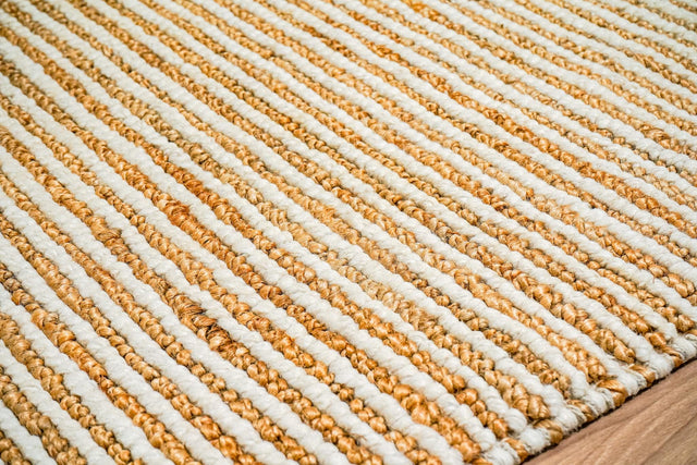 Natural ivory wool jute rug laid flat, full pebble weave stripe view