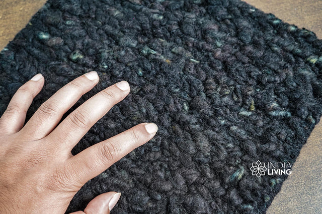 Solid black textured wool rug, flat lay view