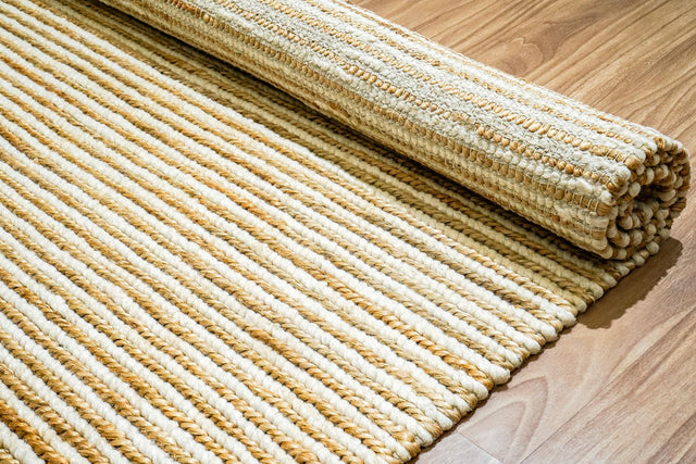 Handwoven wool jute braided rug in natural ivory, flat lay view