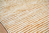 Natural ivory wool jute rug styled in a bedroom setting