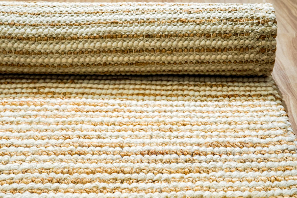 Close-up of pebble weave stripe texture on ivory rug
