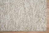 Cashew Loop wool rug — close-up of the pile texture and edge stitching