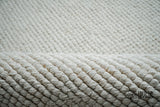 Wool rug corner detail showing loop pile