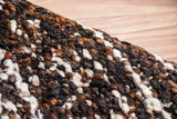 Multicolour wool rug near a hearth setting