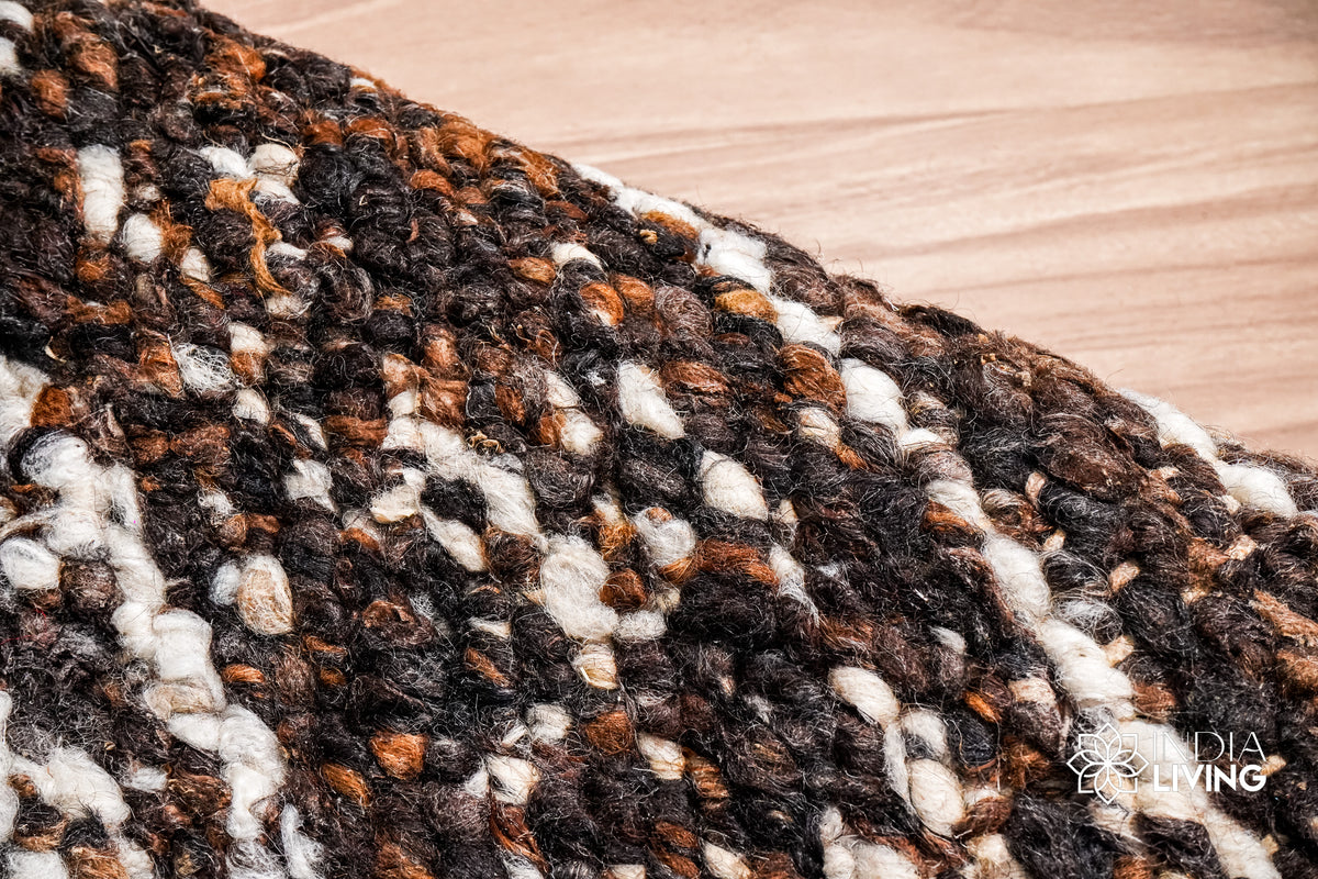 Multicolour wool rug near a hearth setting